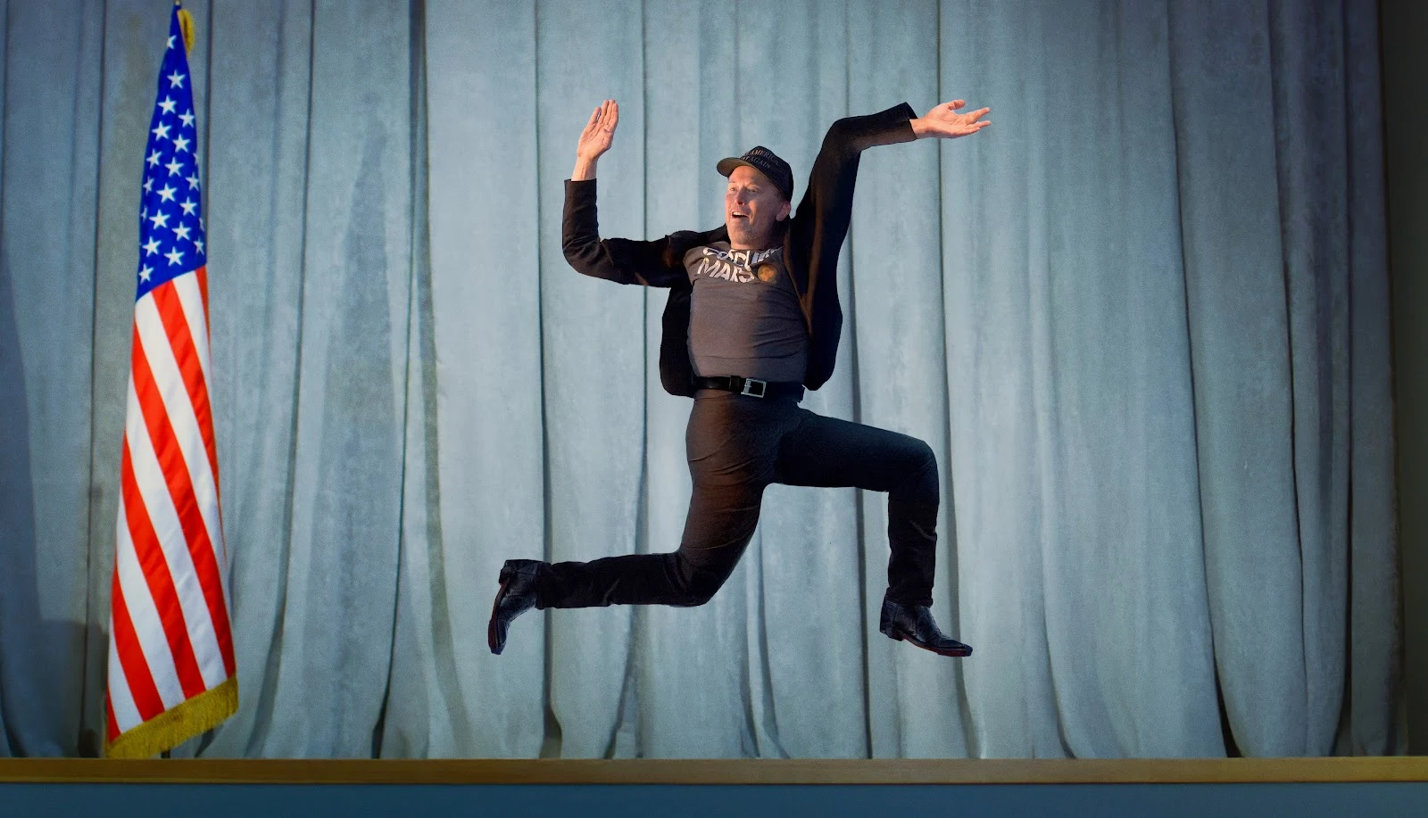 photo edit of Elon Musk doing a jump pose, edited to look like a swastika