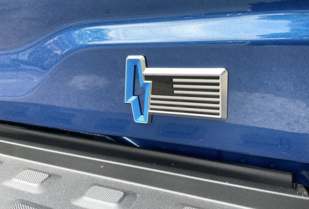 picture of a Ford Lightning's badge which is a Nazi looking lightning bolt with a black and white US flag.