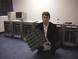 Photo of Paul Kocher holding a very large circuit board