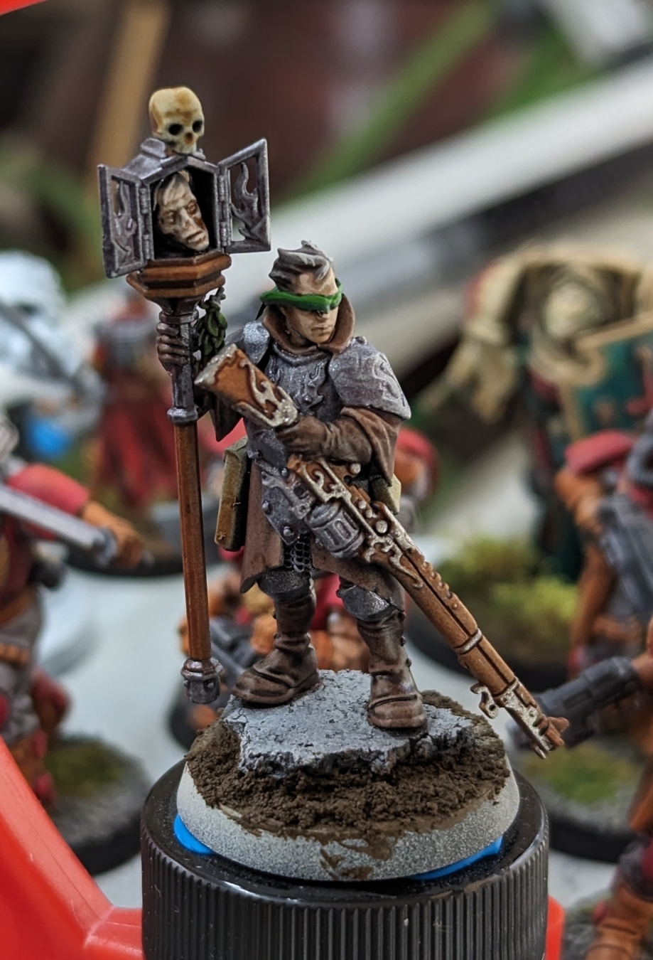 An AoS Cities of Sigmar mini kitbashed with an AdMech rifle and a green stuff blindfold to make a Sniper Priest for Tench Crusade.