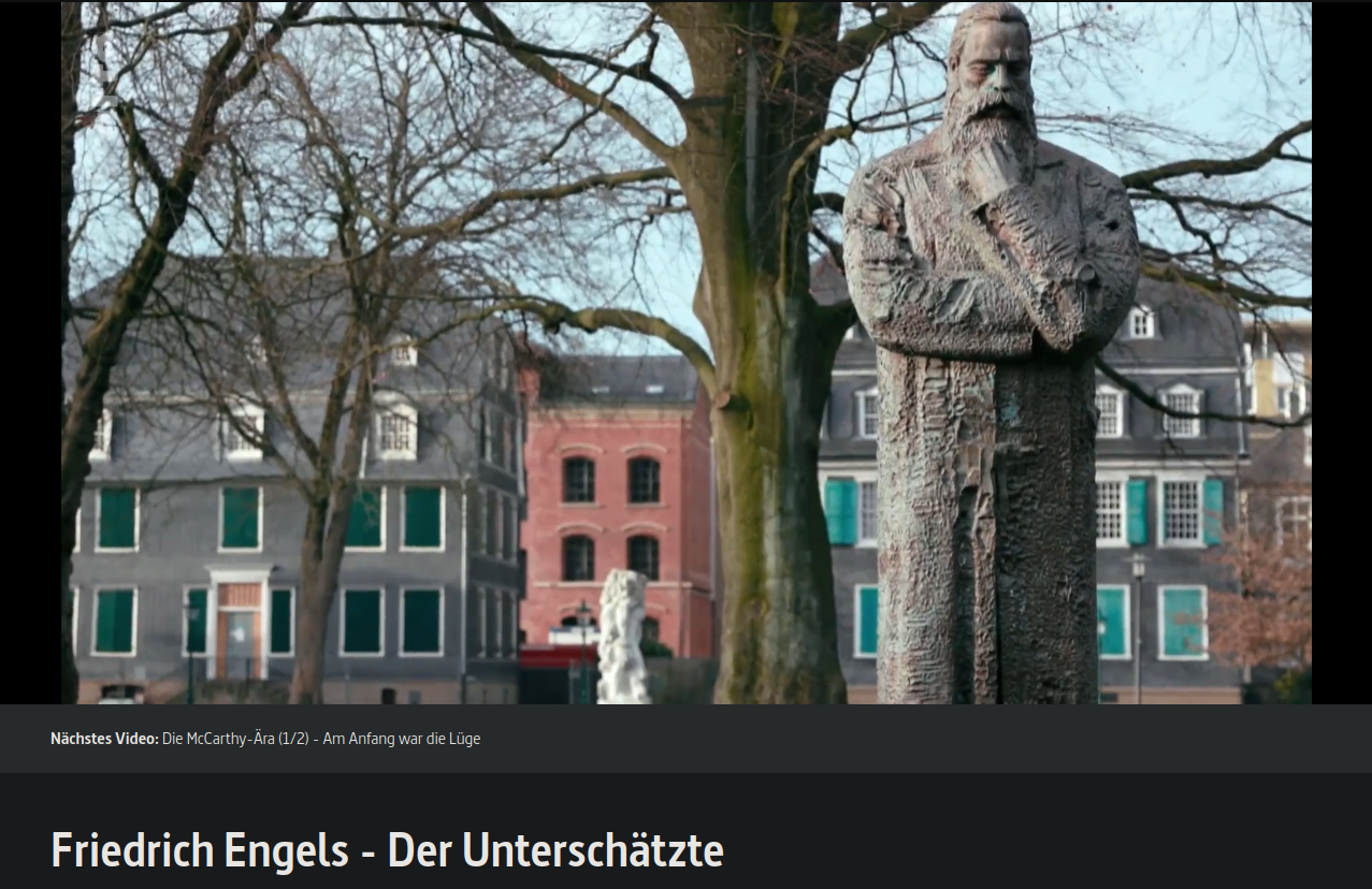 Filmstill: Engels-Statue im Engelsgarten, im Hintergrund das Engels-Haus und das Museum für Frühindustrialisierung