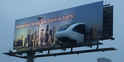 Billboard that says "Monorails Never Get Stuck In Traffic"