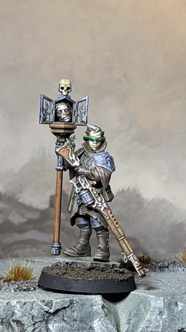 An AoS Cities of Sigmar mini kitbashed with an AdMech rifle and a green stuff blindfold to make a Sniper Priest for Tench Crusade.