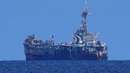 Philippine officials say Chinese forces seized 2 navy boats in disputed shoal, injuring sailors