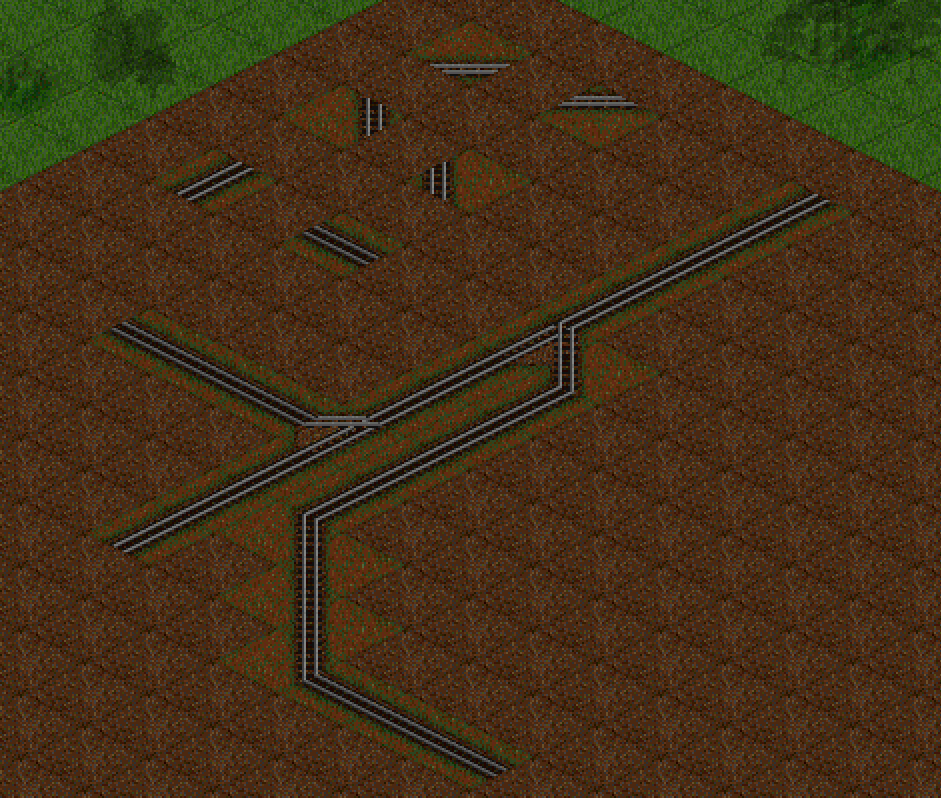A cropped screenshot of OpenTTD, showing pieces of rail. Some isolated, some forming a branching railroad.