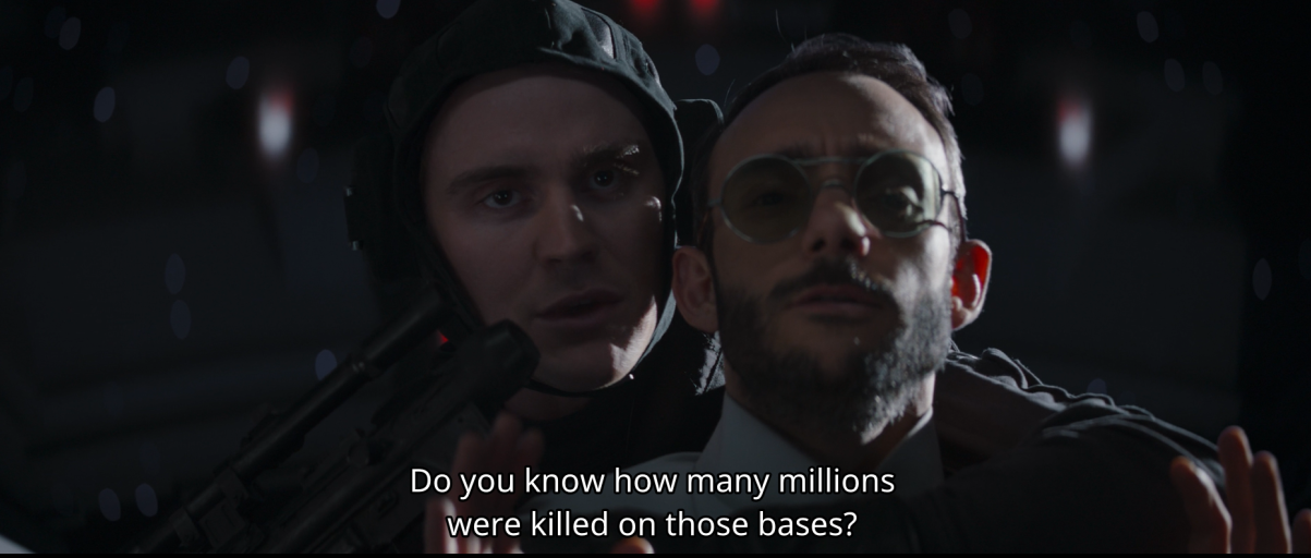 screenshot of an imperial pilot and and Dr. Pershing in the first scene in Chapter 16 of The Mandalorian, with the subtitle "Do you know how many millions were killed on those bases?"