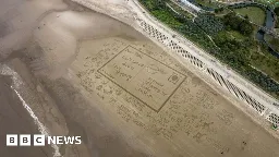 Skegness climate protesters draw giant postcard to PM on beach